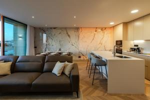 a living room and kitchen with a couch and a counter at The View at The Downtown Faro in Faro