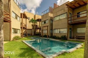 an exterior view of a house with a swimming pool at Casa com Área Privativa Lambari 07 by Qavi in São Miguel dos Milagres