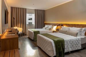 Ένα ή περισσότερα κρεβάτια σε δωμάτιο στο Rio Hotel By Bourbon Luque Asuncion
