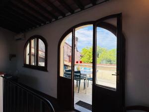 an open door to a patio with a table and chairs at Santa Maria Dreaming Rooftop in Pisa