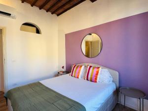 a bedroom with a bed with a mirror on the wall at Santa Maria Dreaming Rooftop in Pisa +32 photos