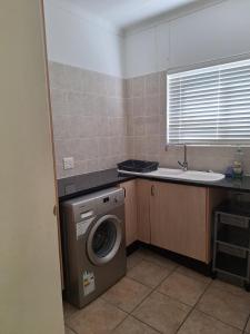 a kitchen with a washing machine and a sink at Waterfront E11 in Swakopmund +22 photos