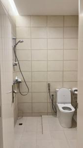 a bathroom with a shower and a toilet in it at بيت الريف in Salalah +34 photos