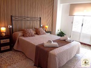 a bedroom with a bed with a towel on it at Casa La Abuela 1982 in La Iruela +15 photos