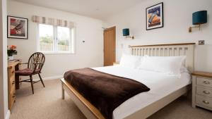 En eller flere senge i et værelse på The Apple House