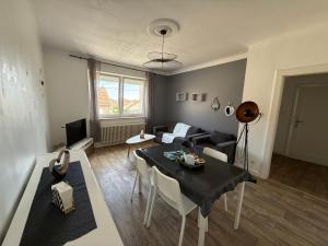 a living room with a table and a couch at Elysium Lodges in Amnéville