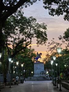 a statue of a horse in a park at dusk at Departamento moderno en el centro de Posadas in Posadas
