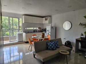 a kitchen and living room with a couch and a table at Departamento moderno en el centro de Posadas in Posadas