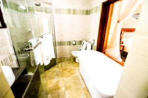 a bathroom with a toilet and a sink at Siritamu Resort & Spa in Bungoma
