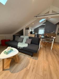 a living room with a couch and a table at Elysium Lodges in Amnéville