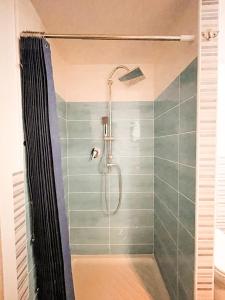 a shower in a bathroom with green tiles at La Tufara Countryside Apartment - Authentic Italian Family Home with free parking in Nocera Inferiore +42 photos