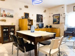 a living room with a wooden table and chairs at La Tufara Countryside Apartment - Authentic Italian Family Home with free parking in Nocera Inferiore