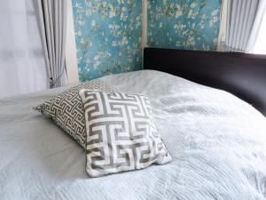 a bed with two pillows on top of it at Shinjuku, 3min walk from Nishi-Shinjuku 5-chome Sta, 3min Shinjuku Sta Switch, Wi-Fi ,Pocketwi-Fi in Tokyo