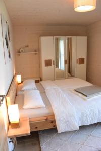 a bedroom with a bed with a laptop on it at Morgenrot Panorama-Apartment 2 - Zwei Balkone in Gnotzheim