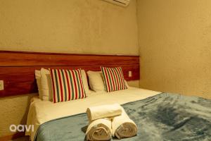 a bedroom with a bed with towels on it at Casa com Piscina Privativa Lambari 107 by Qavi in São Miguel dos Milagres +28 photos