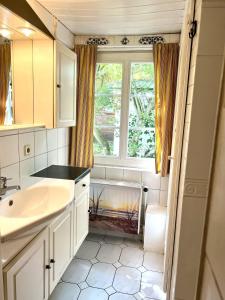 a bathroom with a sink and a window at Ferienhaus-„Alte-Schmiede“ in Westerland (Sylt)