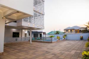 a courtyard of a house with a building at D'Magnolia Luxury Apartments in Ogbojo