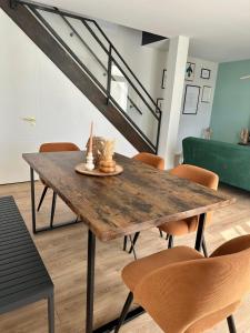 a dining room with a wooden table and chairs at La longère Cosy & Centrale in Bétheny +24 photos