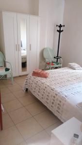 Un dormitorio con una cama y dos sillas. en Casa Santiago 2, en Gela 1 foto más