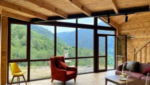 a living room with a view of a mountain at IparAlto in Mestia