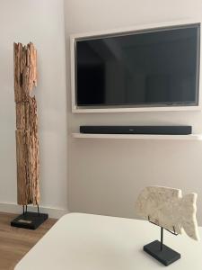 a living room with a flat screen tv and a chair at Marbella-abc-aparts in Marbella +4 photos