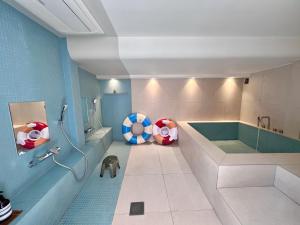 a bathroom with a tub and a beach ball chair at BUSAN Stay 404 in Busan