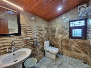 a bathroom with a sink and a toilet at Florence B&B Near Mall Road - Amazing Valley View in Shimla +88 photos
