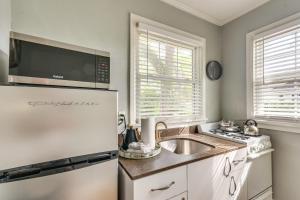 a kitchen with a white refrigerator and a sink at 3 Blocks to Pensacola Bay Charming Apartment! in Pensacola
