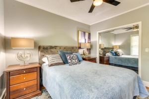 a bedroom with a bed and a large mirror at 3 Blocks to Pensacola Bay Charming Apartment! in Pensacola