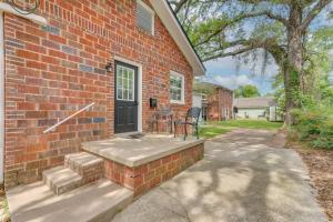 a brick house with a patio and a door at 3 Blocks to Pensacola Bay Charming Apartment! in Pensacola