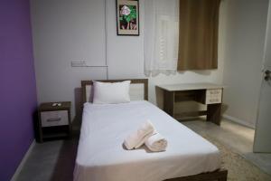 a bedroom with a bed with towels on it at Omega Suites By Platform 357 in Ayios Dhometios
