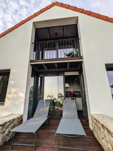 two benches on the front porch of a house at Casa Malcata by Portus Alacer - Quinta Fonte Fria in Carreiras