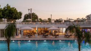 a pool with tables and umbrellas next to a building at Prive Side Suite & Spa Hotel - Adults Only 16 Plus in Side