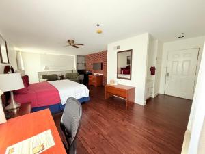 a hotel room with a bed and a table and chairs at Inn at Cemetery Hill in Gettysburg
