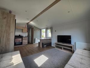 a large living room with a flat screen tv at Haven Presthaven Beach Resort in Talacre