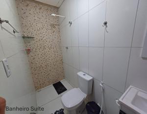 a small bathroom with a toilet and a sink at Casa no centro de Japaratinga in Japaratinga +19 photos