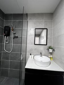 a bathroom with a sink and a shower at The Executive 27 by MySky Putrajaya in Putrajaya