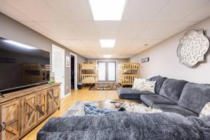 a living room with a couch and a tv at Carolina Moon Cabin in Franklin