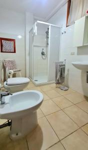 a bathroom with two toilets and a shower at Gente di Mare Apartment Tropea Center in Tropea