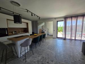 a kitchen and living room with a table and chairs at villa Amethyst in Lozenets
