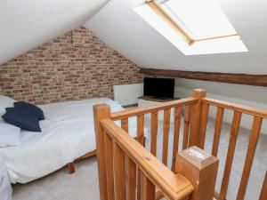 a attic bedroom with a bed and a skylight at Lonsdale Street in Workington
