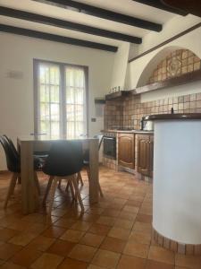 a kitchen with a table and chairs in a room at Villa Lollo in Camporosso