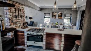 a kitchen with a stove and a counter top at Amara Manor in Otjiwarongo