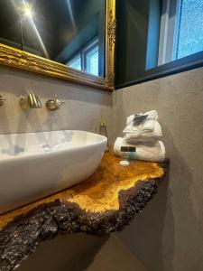 a bathroom with a white sink and a mirror at Cosy Seaside Cottage in Brighton & Hove