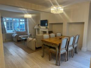 a living room with a wooden table and chairs at Cosy Seaside Cottage in Brighton & Hove