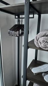 a shelf in a room with a shelf at Spacious, smart apartment near City Centre and Coop Arena Free parking in Manchester