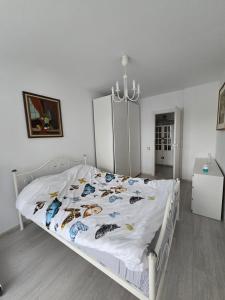 a bedroom with a white bed with shoes on it at Condo in Cluj-Napoca in Cluj-Napoca