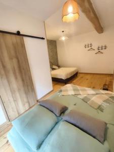 a room with two beds in a room at Chambre d'hôtes Le chant des oiseaux à La Source de nos Racines in Beaufort +41 photos