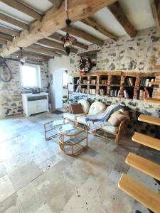 a living room with a couch and chairs in it at Chambre d'hôtes Le chant des oiseaux à La Source de nos Racines in Beaufort