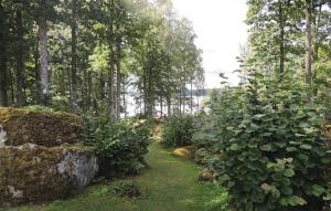 a garden with rocks and plants and trees at Naturskönt boende med tillgång till båt in Vrigstad